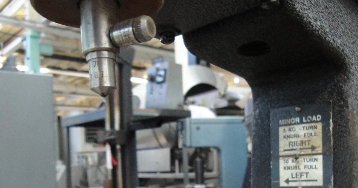 Hardness testing tool steel: indenter and minor load label on a bench Rockwell hardness tester